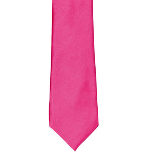 The front of a bright fuchsia solid tie, laid out flat