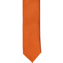 Load image into Gallery viewer, The front of a burnt orange skinny tie, laid flat