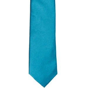 The front of a caribbean blue slim tie, laid out flat