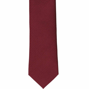 The front of a claret slim herringbone tie, laid out flat