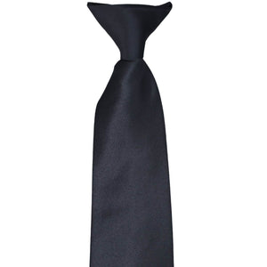 The front knot on a men's dark navy blue clip-on tie