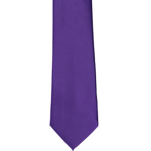 The front of a dark purple slim tie, laid out flat