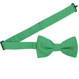 An emerald green bow tie with a band collar open