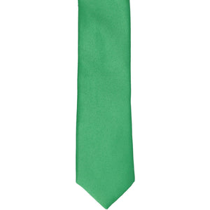 The front of an emerald green skinny tie, laid flat