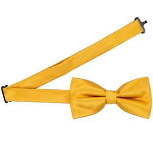 A golden yellow pre-tied bow tie with the band collar open