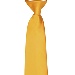The front knot on a golden yellow clip-on tie, laid flat