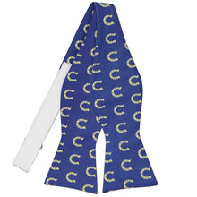 Load image into Gallery viewer, A horseshoe themed self-tie bow tie in blue and yellow, untied