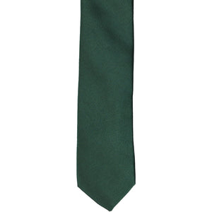 The front of a hunter green skinny tie, laid flat