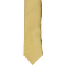 Load image into Gallery viewer, The front of a light gold skinny tie, laid flat