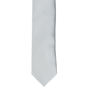 The front of a light silver skinny tie, laid flat