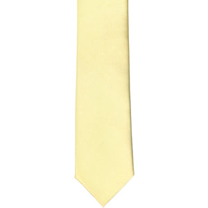 The front of a light yellow skinny tie, laid flat