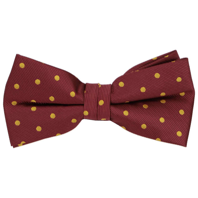 A maroon and gold pre-tied polka dot bow tie