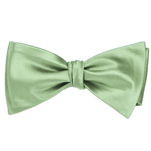 A mint green solid self-tie bow tie, tied