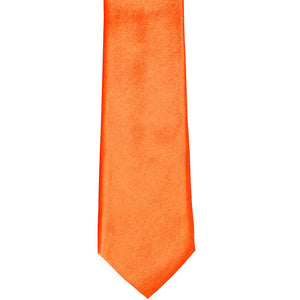 The front of a neon orange solid slim tie, laid out flat