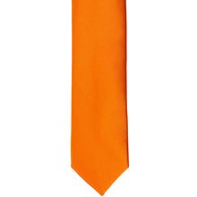 Load image into Gallery viewer, The front of an orange skinny tie, laid out flat