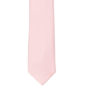 The front of a pastel pink slim tie, laid out flat