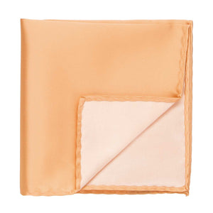 A peach pocket square with the corner flipped up to show the inside
