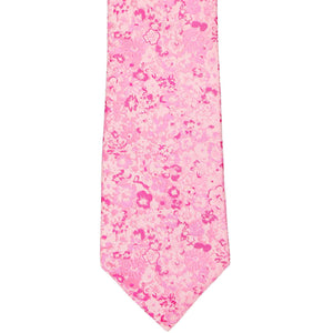 The front of a pink tie with small textured flowers, in an extra long length
