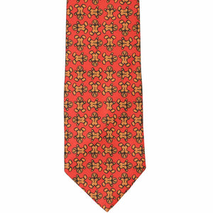 The front of a red tie, laid flat, with a repeated gingerbread pattern