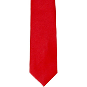 The front of a solid red slim tie, laid out flat
