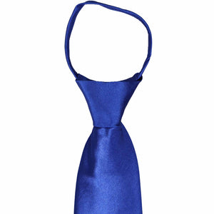 The front knot on a sapphire blue zipper tie