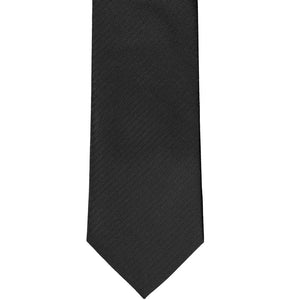 The front bottom of a black silk herringbone tie in a tone-on-tone style