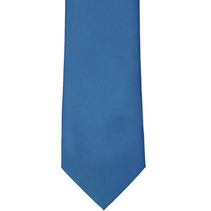 The bottom tip of a blue solid color tie