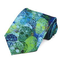 Load image into Gallery viewer, Blue and green sugar skulls randomly on a tie.