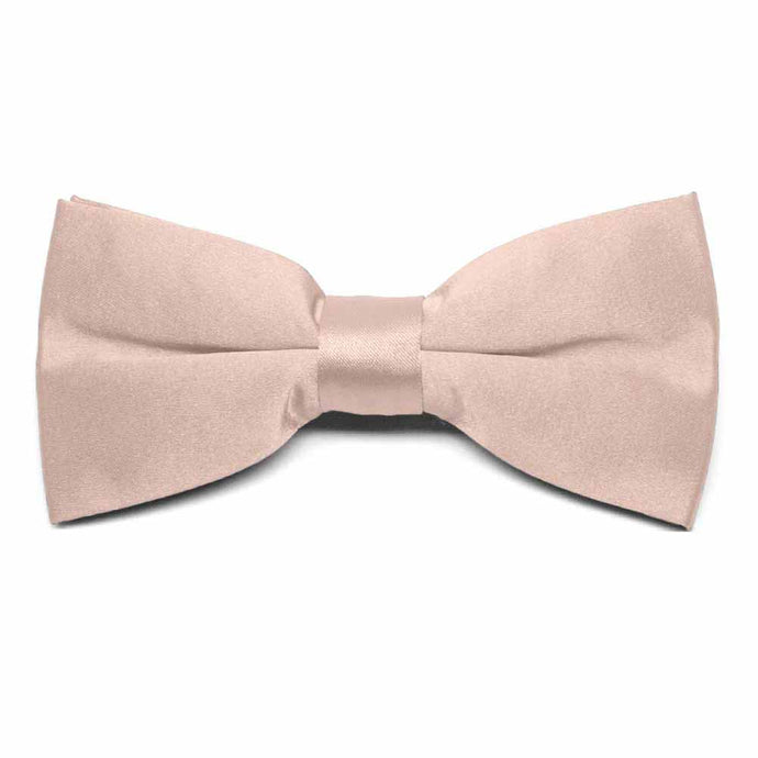 The front of a blush pink clip-on bow tie