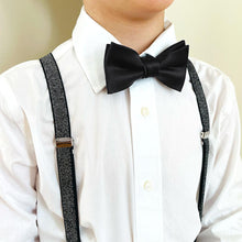 Load image into Gallery viewer, A child wearing a pair of black metallic suspenders with a black bow tie and white dress shirt
