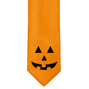 A boys' smiling pumpkin face at the bottom of an orange tie
