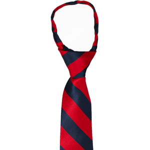 Knot and collar view of a red and navy striped boys zipper tie