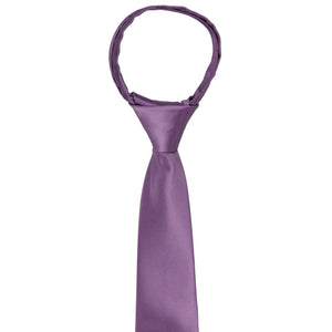 The knot and front of a boys wisteria purple zipper tie