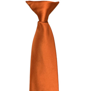 The front and top of a burnt orange clip-on tie