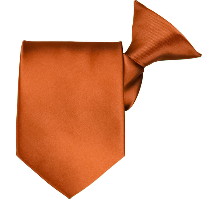 A burnt orange clip-on tie, folded to show off the clip and tie tip