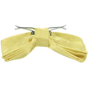 The side view of an opened butter yellow clip-on bow tie