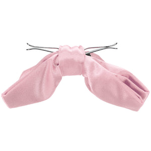 The side view of an opened carnation pink clip-on bow tie