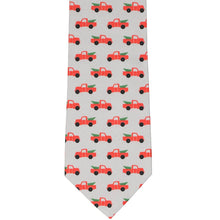 Load image into Gallery viewer, Flat view of a Christmas necktie with red pickup trucks and trees