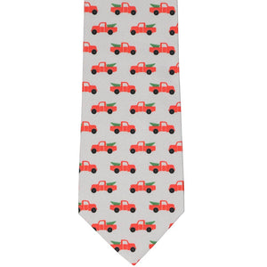 Flat view of a Christmas necktie with red pickup trucks and trees