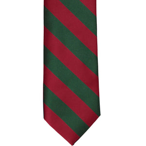 The front of a hunter green and red striped tie, laid out flat