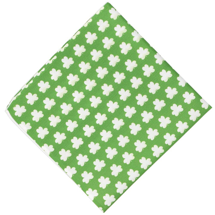 A green novelty pocket square featuring a white shamrock pattern