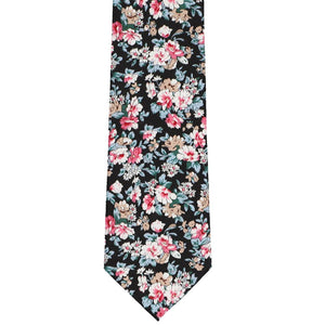 The front of a black and tan floral tie, laid out flat