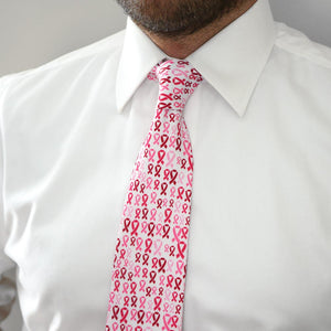 Man wearing a pink ribbon pattern tie and white dress shirt