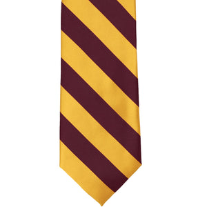 The front of a maroon and golden yellow striped tie, laid out flat