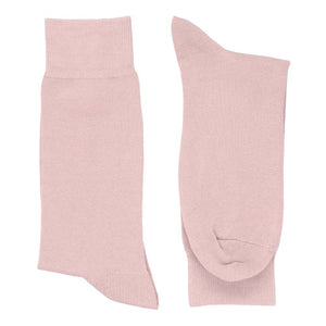 A men's pair of blush pink dress socks folded flat