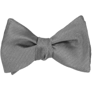 A mercury silver self-tie bow tie, tied, in a tone on tone herringbone pattern
