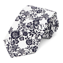 Load image into Gallery viewer, A navy blue and white floral tie, rolled
