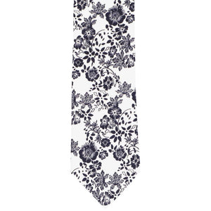 The front of a navy blue and white floral tie, laid flat