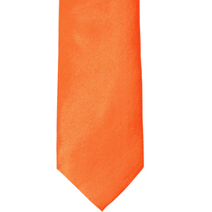 The front of a neon orange solid tie, laid out flat