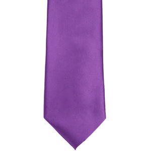 The front tip of a plum violet solid tie